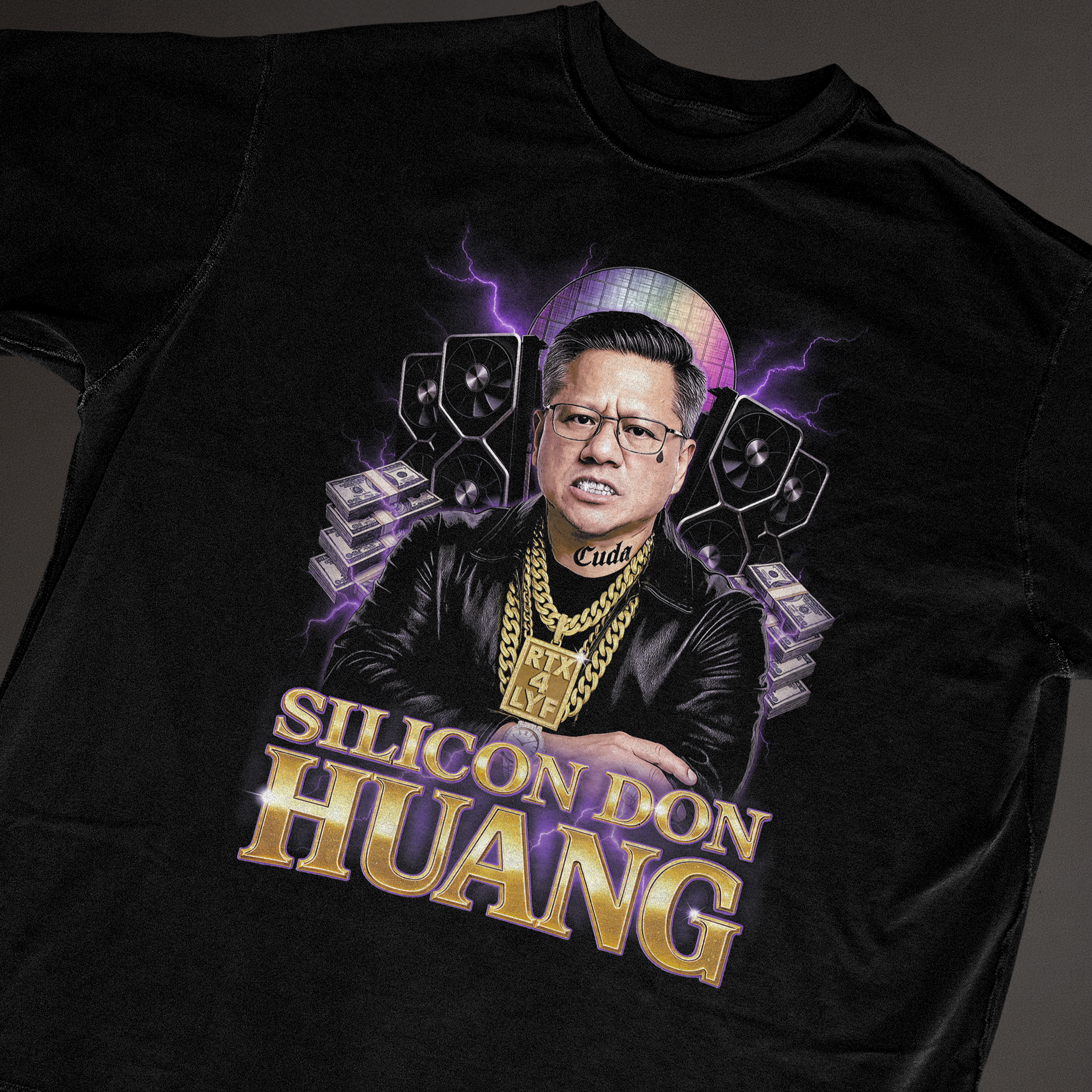 Flat-lay of Silicon Don Huang black t-shirt featuring Jensen Huang graphic with GPUs, purple lightning and text 'Silicon Don Huang'; funny tech CEO meme tee